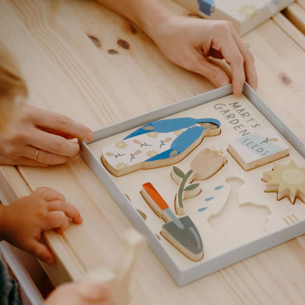 Wooden puzzle with garden-themed pieces on a wooden table.