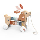Wooden toy dog with wheels and number sequence on a white background