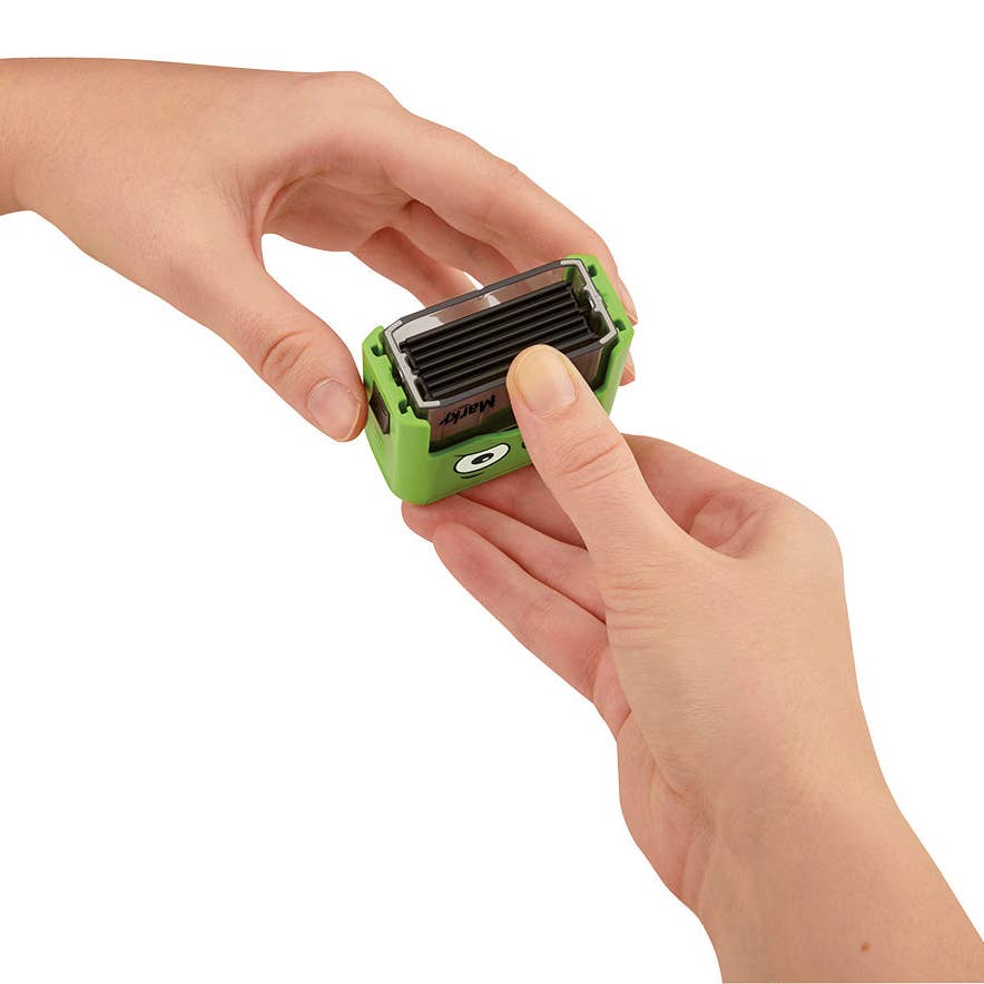 Green and black device held in a hand against a white background