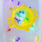 Colorful toy with a yellow base and multicolored accents on a white background