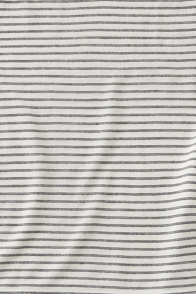 Close-up of striped fabric with thin black lines on a white background