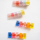 Colorful gummy bear-shaped hair clips on a white background