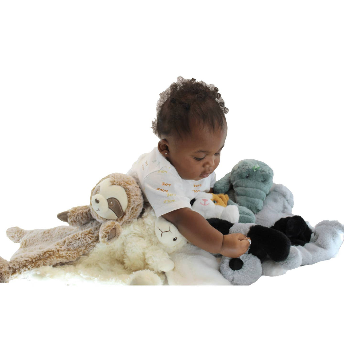 Baby playing with stuffed animals on a white background