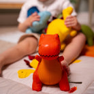 Child playing with colorful stuffed animals on a bed