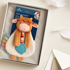 Plush toy with colorful accents in a box, featuring the brand 'Itzy Ritzy'.