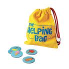 A yellow fabric drawstring bag labeled 'The Helping Bag' in blue text, with a red drawstring and white toggle, shown on a white background with four small round blue cards in front.
