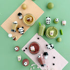 Various desserts and drinks with panda-themed decorations on a green background