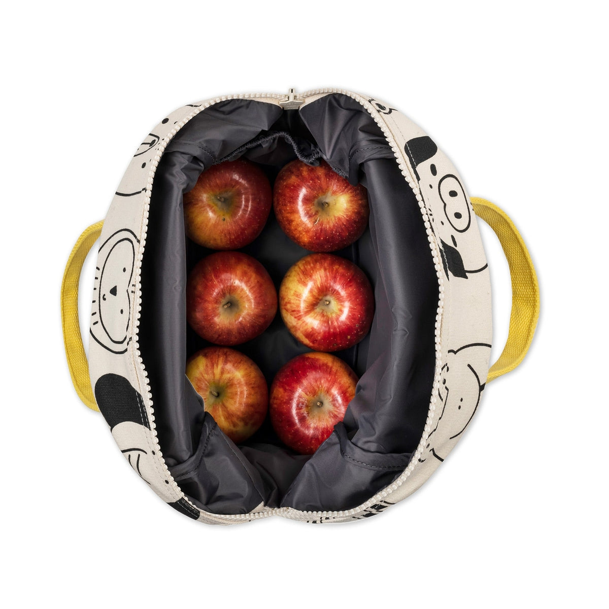 Bag with cartoon face design filled with red apples on a white background