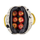Bag with cartoon face design filled with red apples on a white background