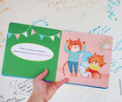 Children's book with a tiger character on a white surface with writing.
