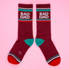 Maroon socks with 'BAD DAD' text on a pink background