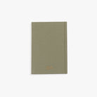 Green notebook with a brand logo on a white background