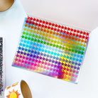 Sheet of colorful star-shaped stickers on a white surface