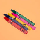 Colorful crayons with faces on an orange background