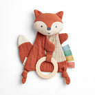 Stuffed fox toy with a ring on a white background