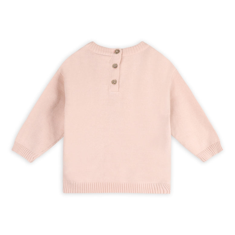 A light pink knit sweater with three buttons on a white background.