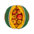 Green and yellow reusable produce bag filled with apples on a white background
