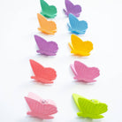 Colorful butterfly-shaped clips on a white background