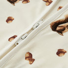 Close-up of a zipper on fabric with acorn pattern