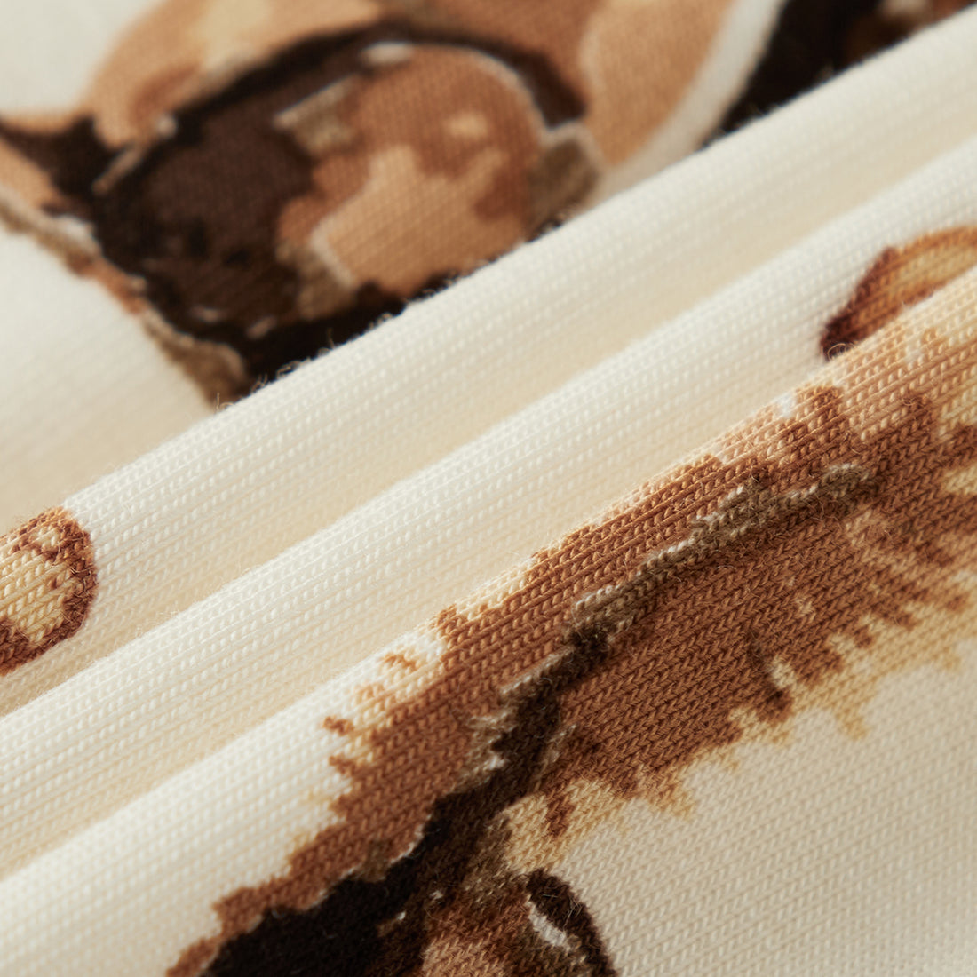 Close-up of fabric with brown animal pattern on beige background