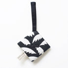 Black and white patterned pouch with a strap on a white background