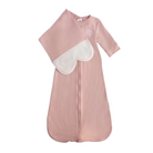 A baby sleep sack in dusty pink with a contrasting white heart-shaped bib panel and a small white embroidered logo on the chest, shown against a plain white background.