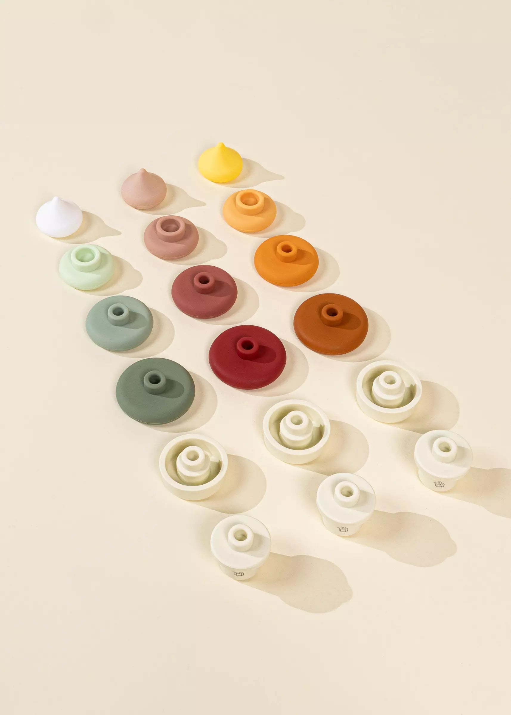 Colorful ceramic beads arranged in a pattern on a beige background