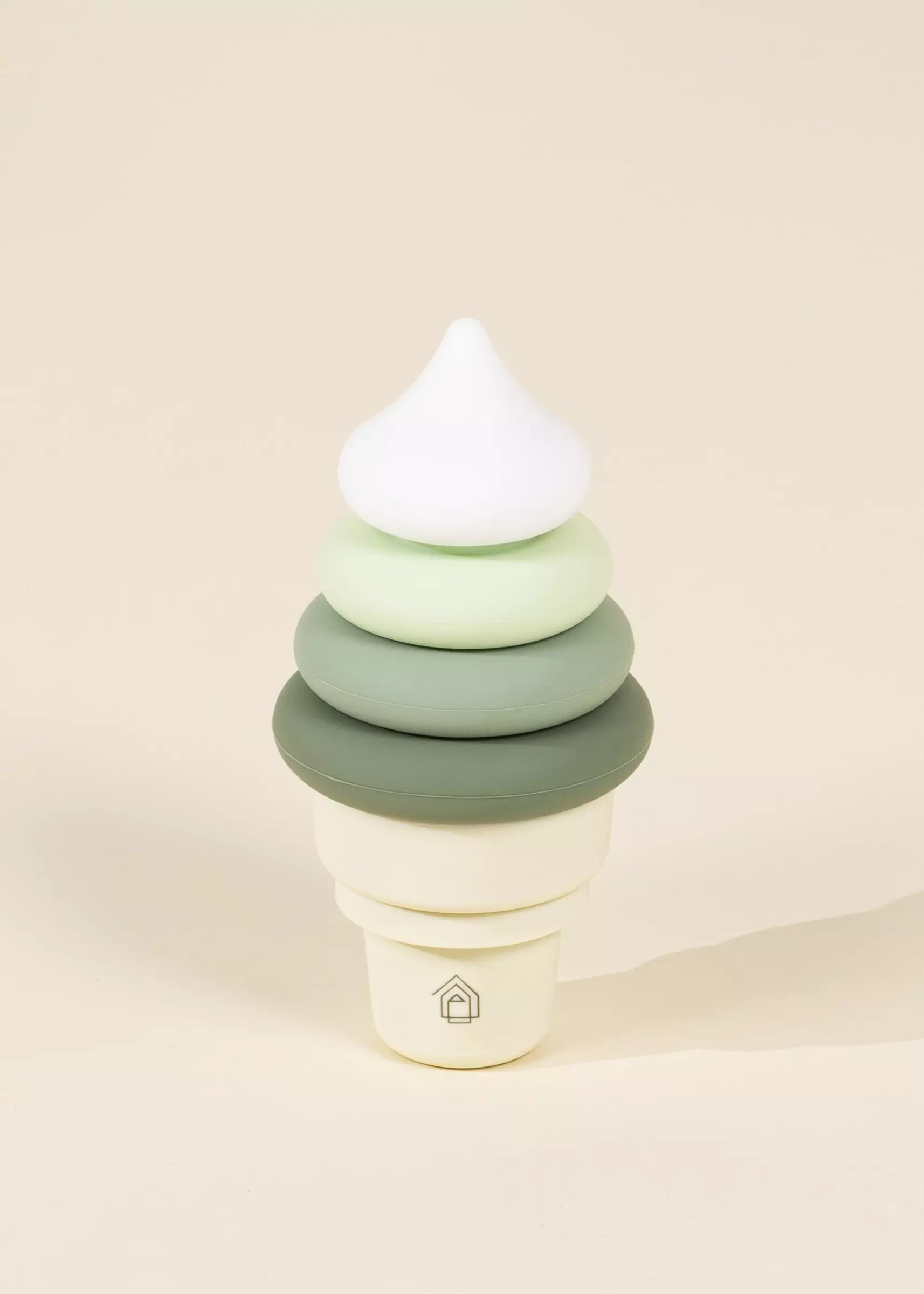 Stack of green and white rings on a beige background
