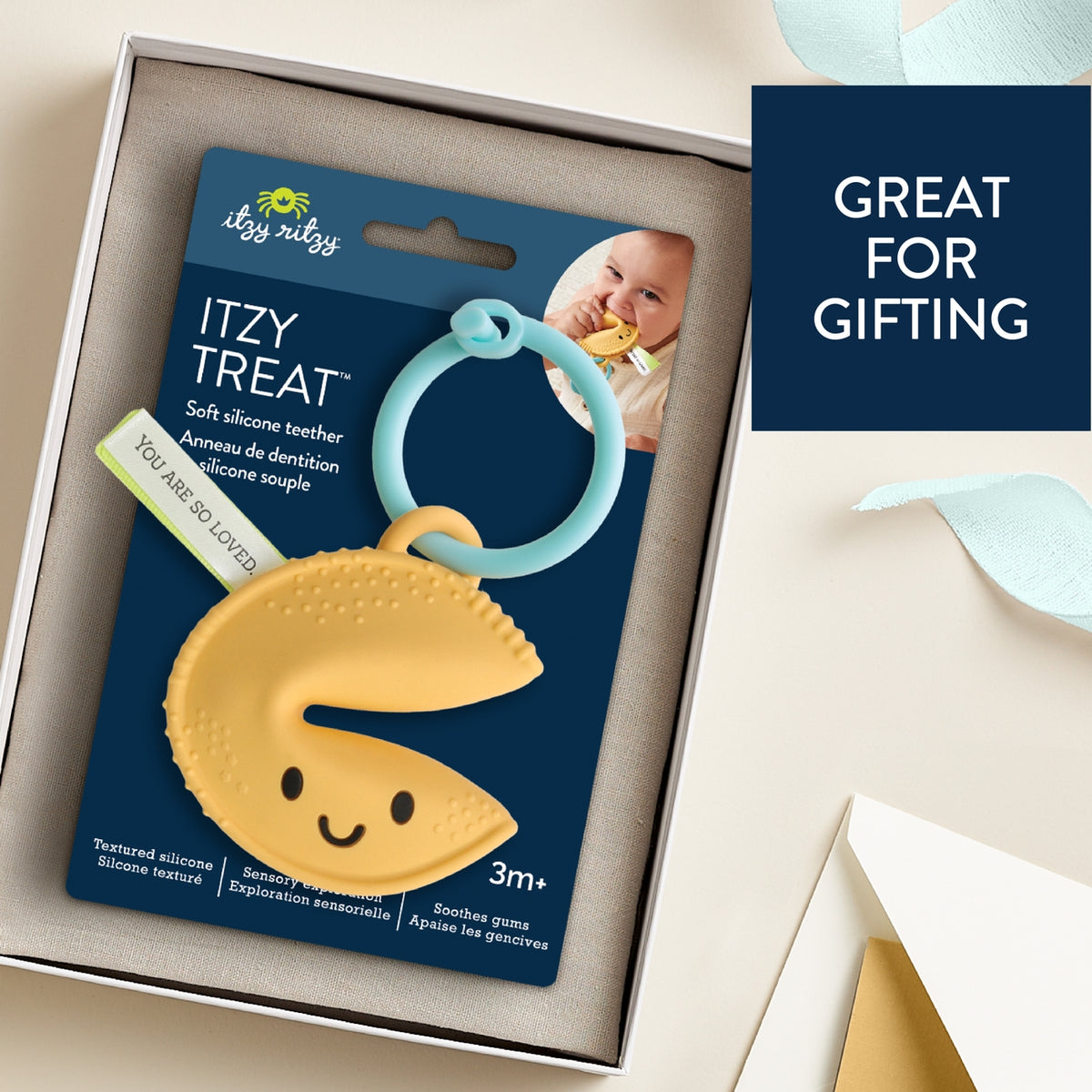 Itzy Ritzy teething ring packaging with text 'Great for gifting' on a beige background