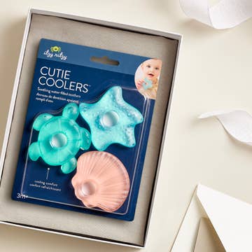 Packaged 'Cutie Coolers' with starfish, turtle, and shell designs on a neutral background.