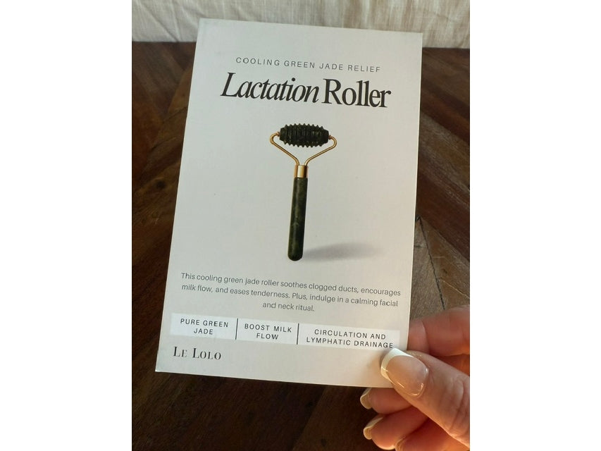 Lactation Roller packaging held by a hand on a wooden surface