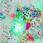 Colorful Christmas-themed decorations on a glittery background