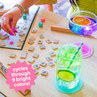 Colorful drink with a straw on a table next to a scrabble game