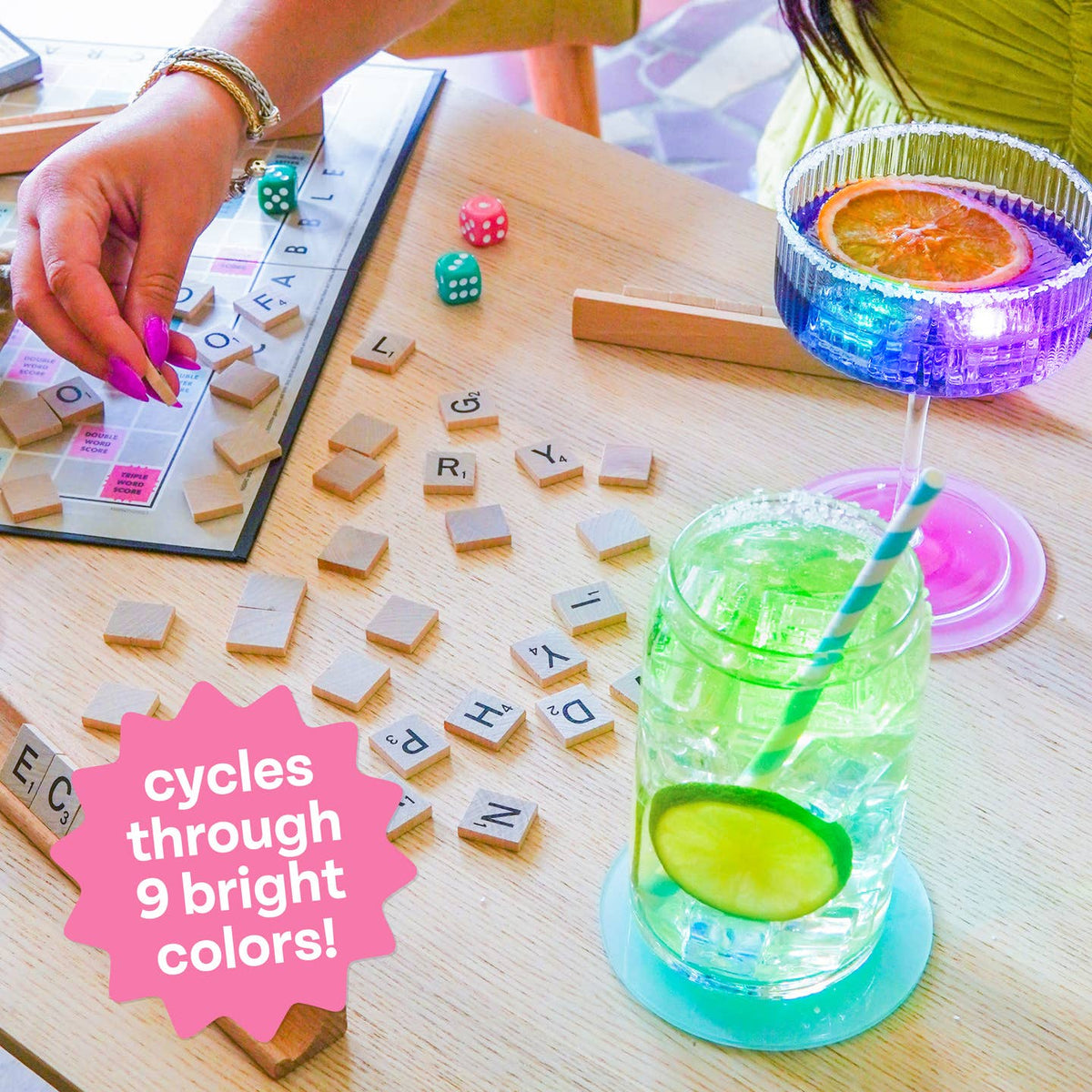 Colorful drink with a straw on a table next to a scrabble game