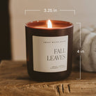 Candle labeled 'Fall Leaves' with dimensions on a wooden surface