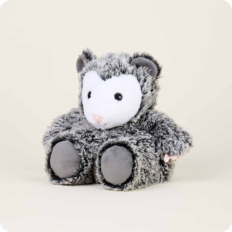 A gray and white fluffy Opossum by Warmies stuffed animal with round black eyes, a pink nose, and dark gray paws, sitting upright against a white background.