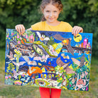 Girl holding a colorful puzzle with a nature-themed design