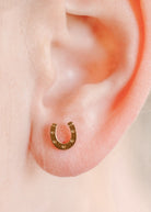 Horseshoe-shaped earring on a person's ear