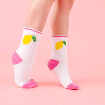 White socks with colorful lemon designs on a pink background