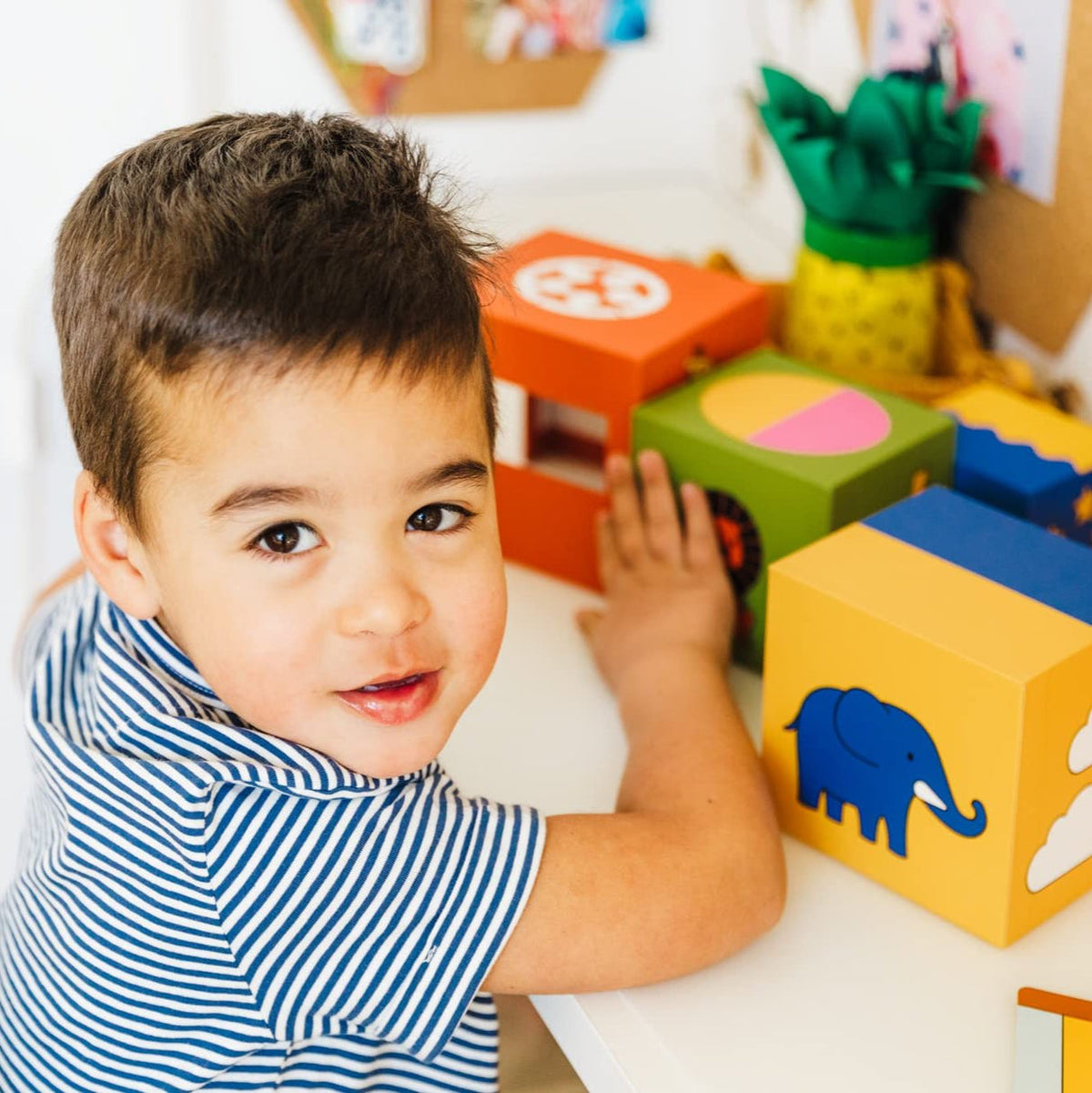 Child playing with colorful blocks in a playful setting