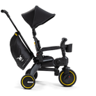 Black children's tricycle with yellow wheels on a white background