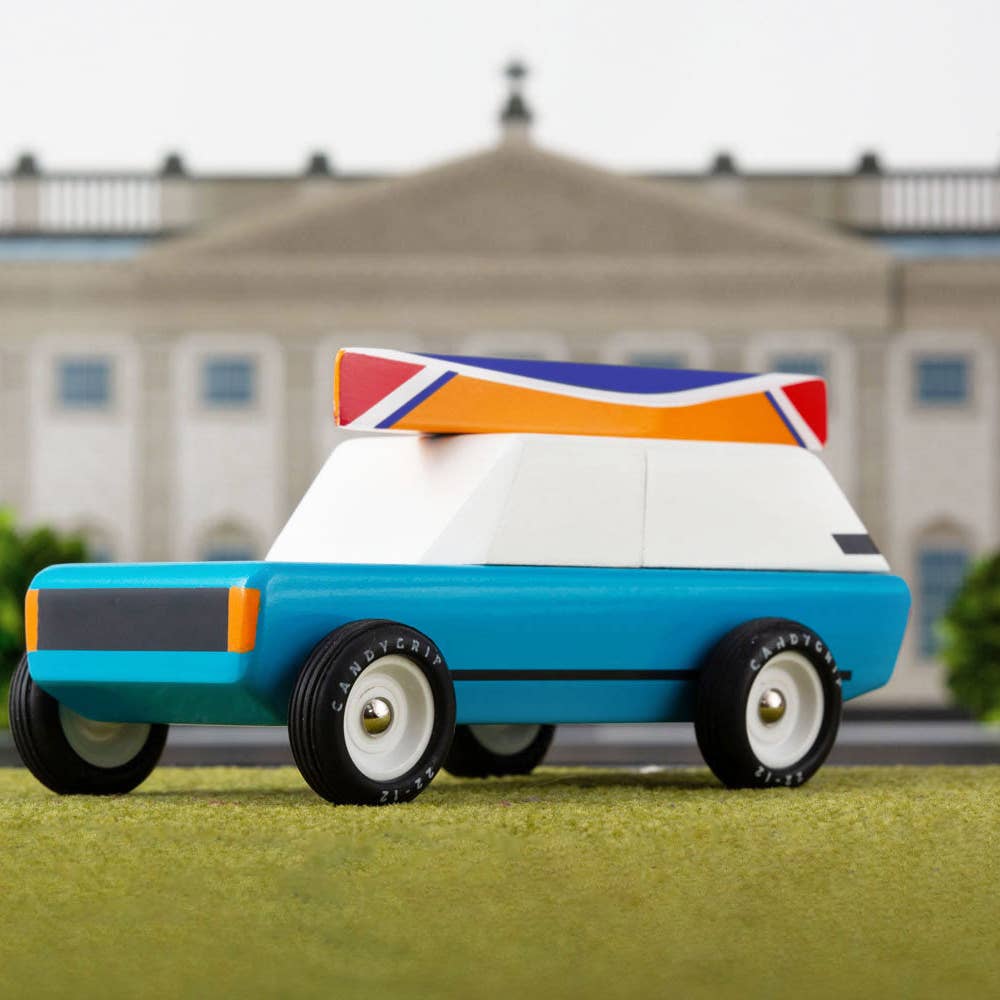 Model car with a colorful roof in front of a building
