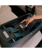 Car seat base installation process with a hand adjusting straps