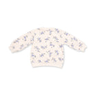 A cream-colored long-sleeve sweatshirt with an all-over small blue and purple floral pattern, shown flat against a white background.