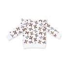 A white long-sleeve baby sweater with an all-over pattern of brown and silver bow sequins, shown flat on a white background.