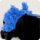 A black and blue Axolotl Junior plush toy by Warmies, viewed in profile close-up, highlighting its soft black body and the vibrant blue feathery external gills.