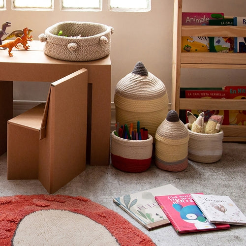 Children's play area with toys, books, and storage baskets on a carpeted floor.