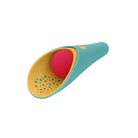 A colorful silicone baby teething toy or oral gummy holder, featuring a teal outer shell, a yellow inner cup with perforations, and a bright pink ball inside, shown on a solid white background.
