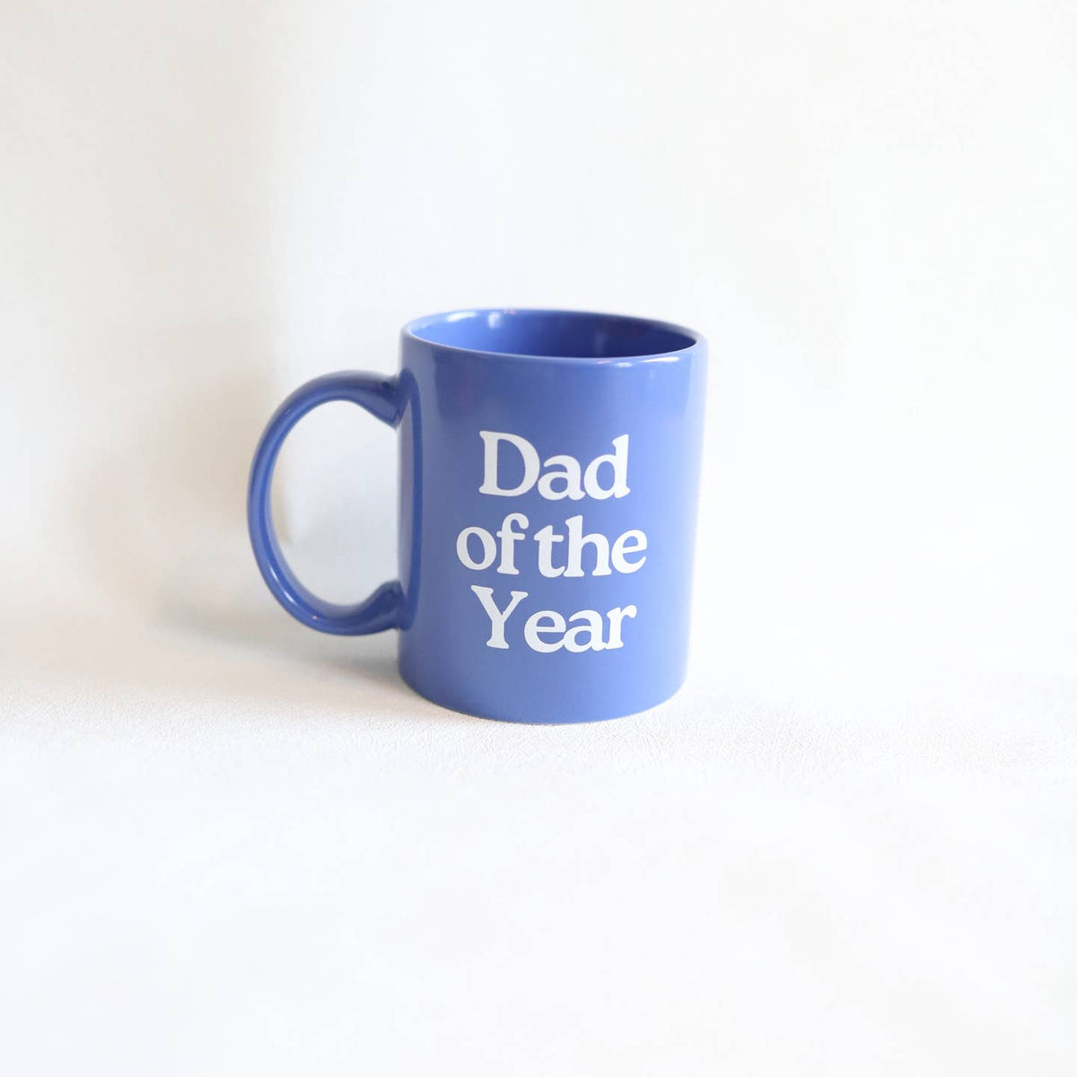 Blue mug with 'Dad of the Year' text on a white background