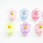 Pastel-colored flower-shaped objects on a white background